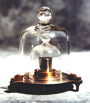 K48 came from the second batch of kilogram replicas to be produced. It was delivered to Denmark in 1949 with an official mass of 1&nbsp;kg+81&nbsp;&micro;g. Like all other replicas, it is stored under two nested bell jars virtually all the time. Still, its mass and that of the IPK diverged markedly in only 40 years; the mass of K48 was certified as 1&nbsp;kg+112&nbsp;&micro;g during the 1988&ndash;1992 periodic verification.