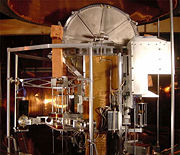 The NIST&rsquo;s watt balance is a project of the U.S. Government to develop an &ldquo;electronic kilogram.&rdquo; The vacuum chamber dome, which lowers over the entire apparatus, is visible at top.