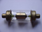 Uranium glass used as lead-in seals in a vacuum capacitor