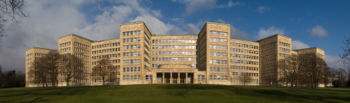 Panorama of the Poelzig building from the south, demonstrating how the curved shape of the building's fa&ccedil;ade reduces the impact of its scale