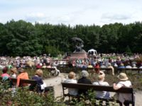 Sunday concert at Chopin statue. White canopy (right) shelters pianist.