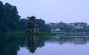 Ho&agrave;n Kiếm Lake in the centre of Hanoi, with the streets of the old town in the background (1999)