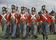 Reenacters of the 33rd Regiment of Foot Wellingtons Redcoats who fought in the Napoleonic Wars, 1812 &ndash; 1815, here showing the standard line 8th Company