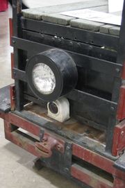 The coupler pocket (just below the two lights) for a link and pin coupler on a 15 inch (381 mm) gauge speeder.