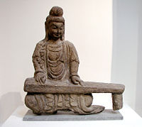 Rock carving of a bodhisattva playing a guqin, found in Shanxi, Northern Wei Dynasty (386&ndash;534).