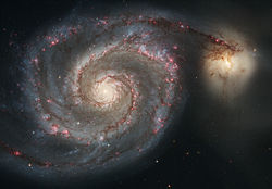 Strings of red H&nbsp;II regions delineate the arms of the Whirlpool Galaxy.