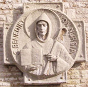 Carving of St. Benedict of Nursia, holding an abbot's crozier and his Rule for Monasteries (M&uuml;nsterschwarzach, Germany).
