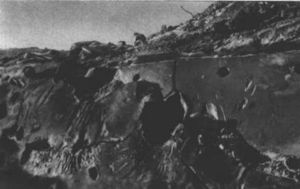 A destroyed German bunker, showing shell impacts in its steel plating