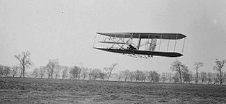 Orville in flight over Huffman Prairie in Wright Flyer II. Flight #85, approximately 1,760&nbsp;feet (536&nbsp;m) in 40 1/5 seconds, 16 November 1904.